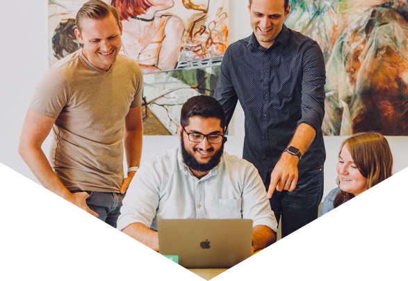 Group of people smiling at laptop screen