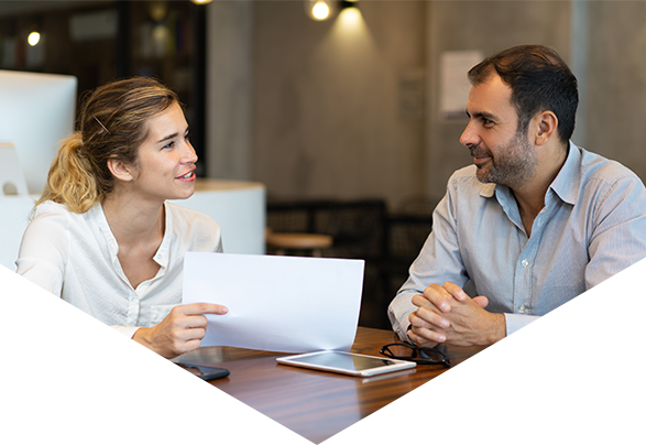 Man and woman sat at desk discussing document