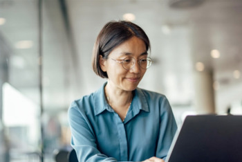 Ambitious asian banker, approving a loan to her customer, at the bank