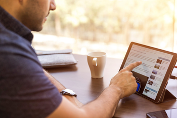 Man reading article on iPad