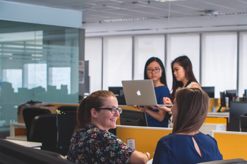 Women talking in office