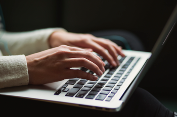 Person typing on laptop
