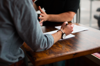 Two people in discussion at desk