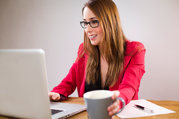 Woman using laptop at desk