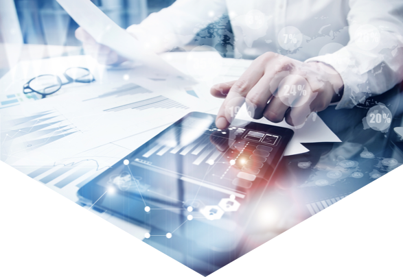 Man sat at desk holding document and viewing data on an iPad